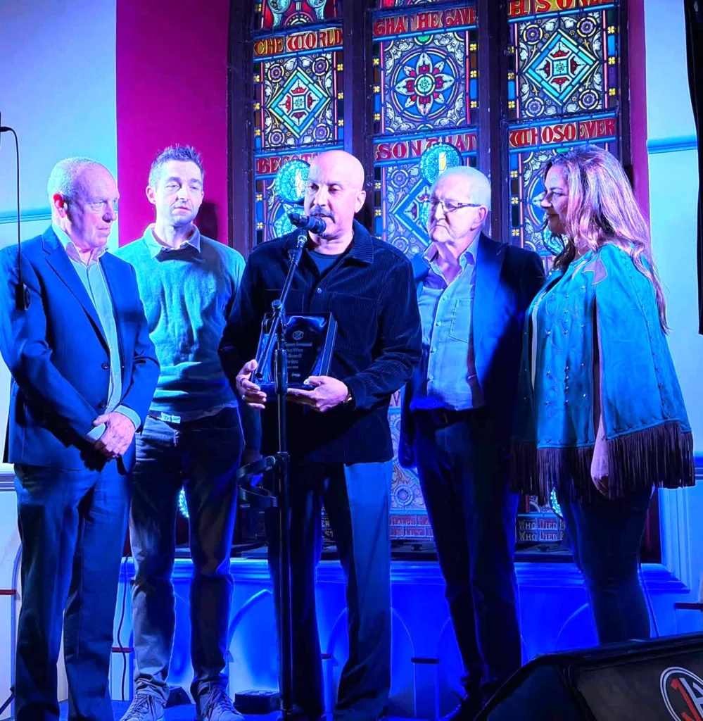 The winner of the 2026 Tipperary International Song of Peace, Leslie Bowe, with his award_